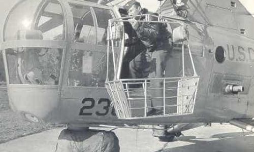 LT Stew Graham at the hatch of a HO3S with a rescue basket attached to the hoist. With the advent of the HO4S the basket could be brought inside the cabin.